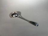 a silver spoon sitting on top of a white counter