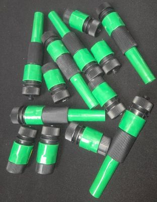 a close up of a bunch of green hoses on a black surface