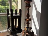 a candle that is sitting on a window sill next to some oranges