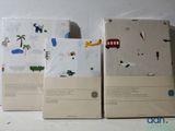 three boxes with different designs on them sitting on a table