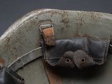 an old leather case with a metal handle