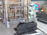 a luggage cart with a bag on it in a warehouse