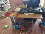 a workbench with a laptop on top of it in the middle of a room
