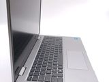 a silver laptop computer sitting on top of a white table