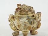a white and brown vase with a fish on it