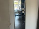 a mirror in the corner of a room with a table in the background