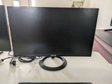 a computer monitor sitting on a desk with a keyboard and mouse