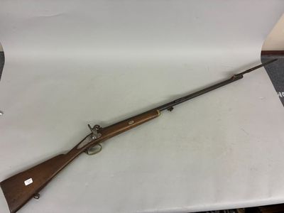 a rifle that is sitting on top of a table