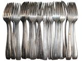 a lot of forks that are lined up on a table