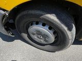 a yellow truck that is parked on the side of the road