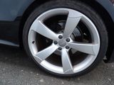 a close up of a car ' s wheel on the street