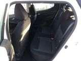 the back seats of a white car with black seats and a red button