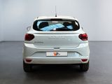 the rear end of a white car in a white room