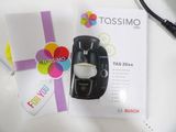 a coffee maker sitting next to a card and a pair of scissors