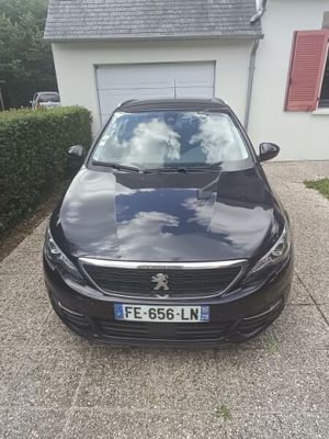 a picture of a black car parked in front of a house