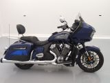 a blue motorcycle that is parked in a white room