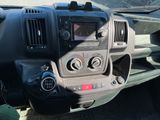 a dashboard of a truck with a radio and a steering wheel