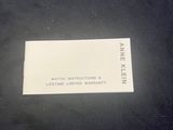 black and white photograph of a business card on a black surface