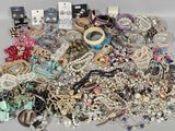 a pile of assorted jewelry sitting on a table