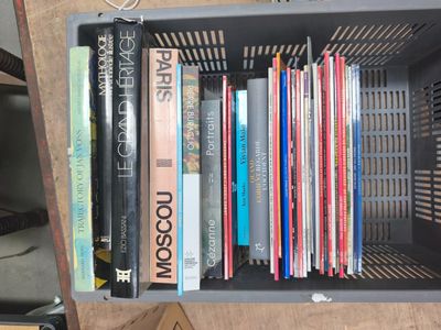 many books that are sitting in a box on a table