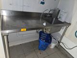 a stainless steel sink with a blue basket underneath it