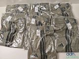 several pairs of men ' s khaki pants are wrapped in plastic