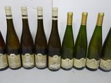 six bottles of wine are lined up in a row on a table