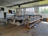 a room with a lot of tables and benches in it