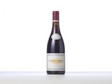 a bottle of red wine sitting on top of a white table