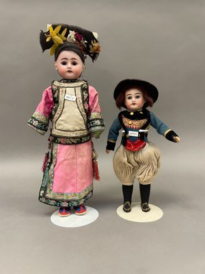 une paire de poupées en porcelaine représentant un garçon et une fille en costume traditionnel