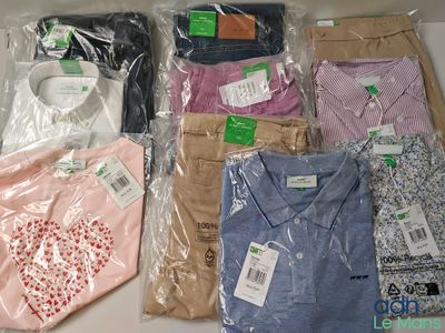 a lot of men ' s shirts in plastic bags on a table