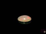an image of a white fire opal in the dark