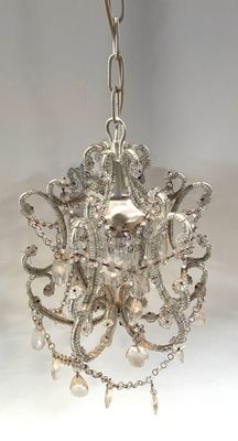 a silver chandelier hanging from a chain