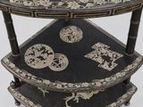 a three tiered table with a decorative design on it