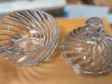 two clear glass containers sitting on a table