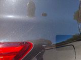 the rear end of a car with a sticker on the side of it