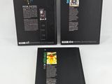 three black boxes with pictures of flowers on them on a white surface