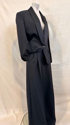 an image of a mannequin wearing a black suit and tie