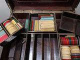 many stacks of books in a case on a table