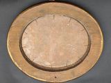 a wooden plate with a circular design on it