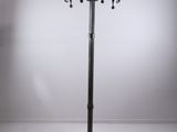 a tall metal pole with three candles on top of it