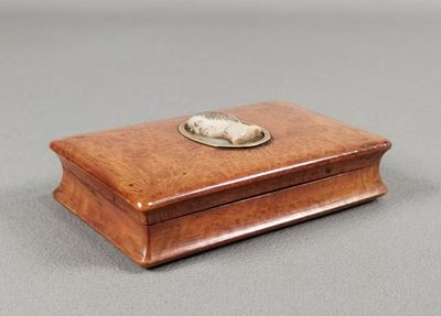 an old wooden box with a silver plate on top