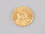 an image of a close up of a gold coin on a white surface