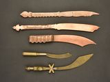 several different types of knives and knives on a black surface