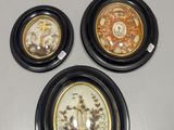 three plates with different designs on them on a white surface