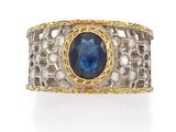 a close up of a ring with a blue stone in it
