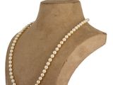 a close up of a mannequin with pearls on a white background