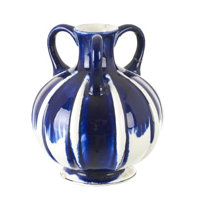 a blue and white vase sitting on a white surface