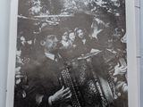an old black and white photo of a group of people playing an accordion