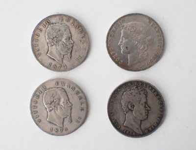 four different types of silver coins on a white surface